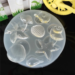 Translucent silicone resin mold featuring sea star and shell shapes for DIY crafts