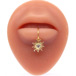 Close-up of golden sunburst faux lip ring with sparkling center zircon on model