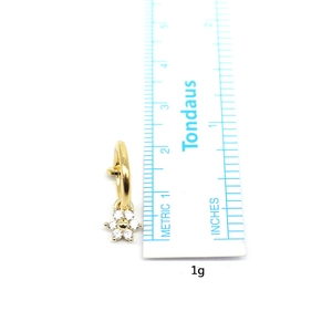Gold-plated floral belly rings with white zircons shown next to a ruler for size