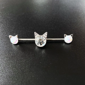 Detailed macro view of cat-themed opal zircon ear bridge piercing in silver steel