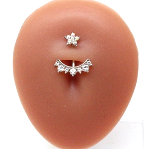 Star and curved zircon naval ring piercing on silicone model showing fit and style