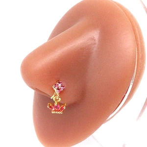 Detail of a gold nose ring with pink zircon flowers and a crown pendant on a silicone nose
