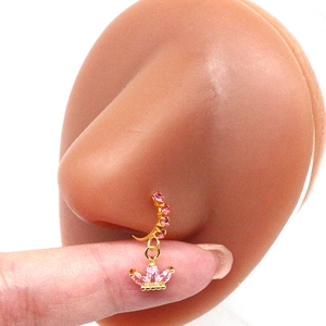 Detail of a gold nose stud featuring pink marquise stones in a floral cluster design