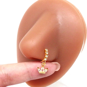 Detail of golden crown nose ring with marquise rhinestones on a silicone nose model