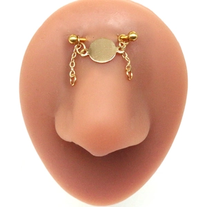 Detailed view of golden bridge piercing with double chains on silicone nose model