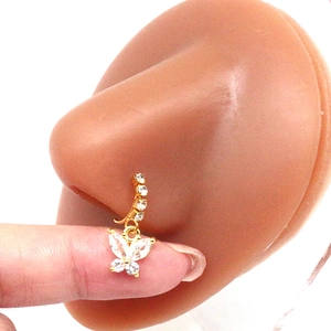 Detail view of golden nose ring with butterfly pendant and zircons on nose model