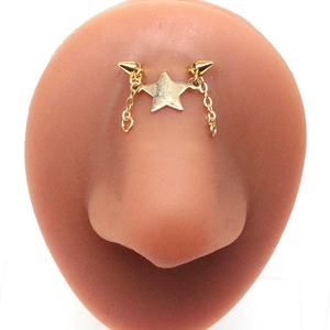 Golden star eyebrow piercing with dual chains and spikes on a silicone nose model