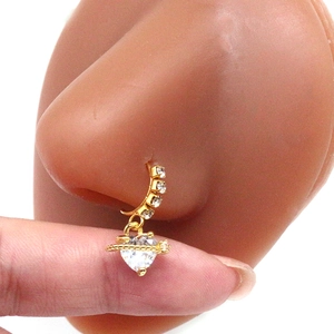 Close-up of gold heart nose ring with zircon stones on a model's nose profile