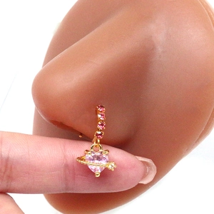 Detail of gold heart nose ring with pink zircon and rhinestone accents on model