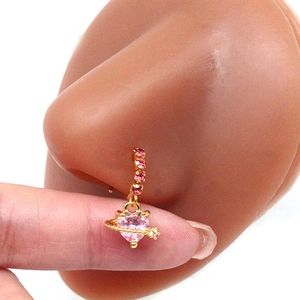 Detail view of pink heart crystal nose ring in gold finish on a silicone model