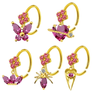 Macro detail of 5 gold nose rings with pink butterfly and heart-shaped zircon stones