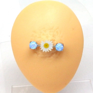 Macro shot of a stainless steel nipple ring featuring blue opal stones and white daisy detail