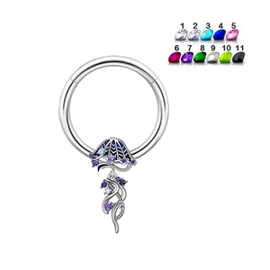Detailopname van kwal navelpiercing met paarse en blauwe zirkonia stenen op wit metaal