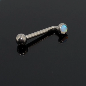 Macro shot of G23 titanium curved barbell featuring blue opal stone and polished silver finish