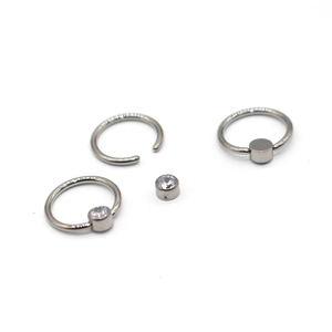 Detail view of G23 titanium body piercing bars with silver zircon stone settings