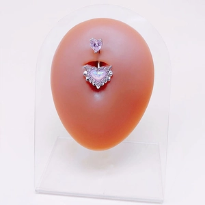 Pink heart opal belly button ring with silver angel wings on silicone body model