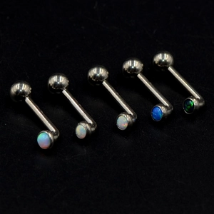Five pieces of G23 titanium curved barbells with vibrant colorful opal stones for piercings