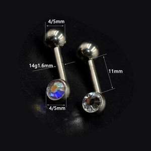 Macro detail of G23 titanium curved barbell piercings with 1.6mm gauge and crystal stones