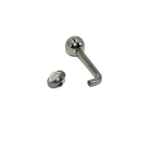 Macro detail of G23 titanium curved labret stud with internal thread and AB zircon gemstone