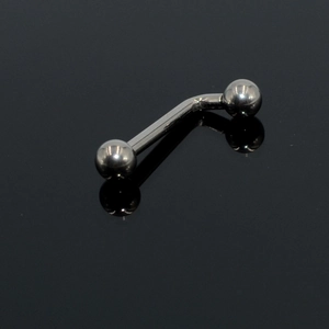 Close-up of polished G23 titanium curved barbell body piercing with symmetric beads