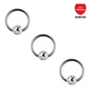Detailed close-up of G23 titanium ASTM F136 captive bead rings with clear cubic zirconia