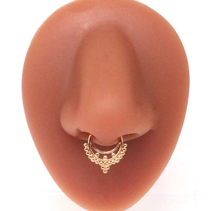 Detailed close-up of gold non-piercing septum ring with beaded trim on nose model