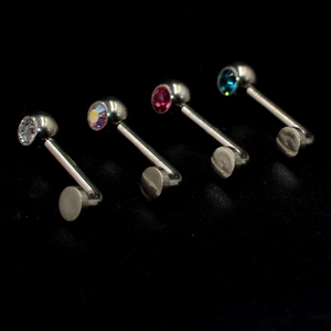 Detail of G23 titanium labret studs with colorful claw-set zirconia in four vibrant colors