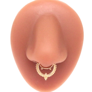 Macro shot of gold non-pierced septum ring with beaded double layer on nose model