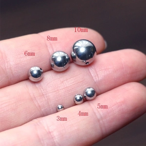 Polished G23 titanium or steel metal beads showing sizes 3mm to 10mm for body jewelry
