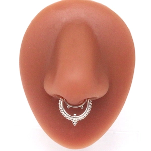 Detailed view of a silver double-layered septum ring with beaded edges on a silicone nose model