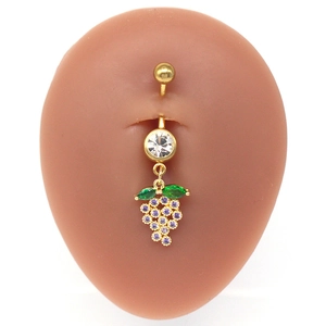 Macro view of gold belly ring with purple crystal grape cluster and green leaf details