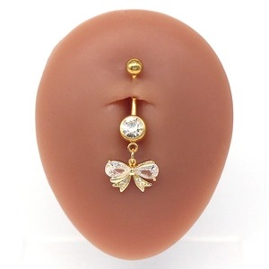 Gold bow belly button ring with sparkling heart cubic zirconia on silicone model