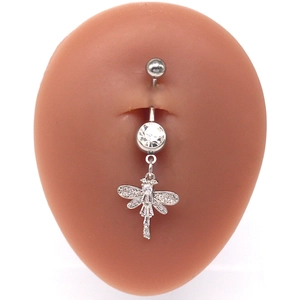 Macro shot of silver stainless steel dragonfly belly ring with sparkling zircon stones