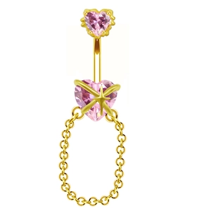 Detalle de piercing de ombligo con circonita rosa, estrella dorada y cadena colgante