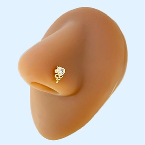 Detail of heart-shaped gold nose stud with clear zircon on silicone nose model