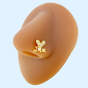 Macro detail of a golden Love letter nose stud with tiny zircon stones on a silicone model