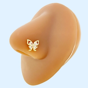 Close-up of golden butterfly nose stud featuring teardrop-shaped sparkling zirconia stones