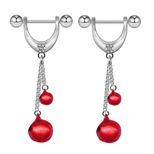 Detail of silver nipple rings featuring red festive bells and delicate double chains
