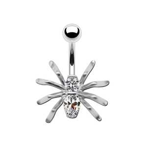 Macro detail of silver spider navel ring with sparkling round and oval cubic zirconia