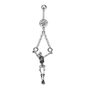 Detailed view of silver skull navel piercing with hanging chains and clear zircon crystal