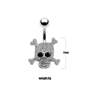 Close-up of a punk style skull belly ring with inlaid crystals, height 17mm, weight 3g