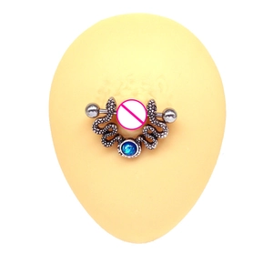 Detail of silver double snake nipple ring with a round blue opal on a display model