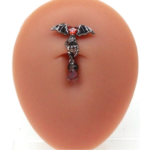 Gothic bat navel ring featuring a red heart stone and skull hand with teardrop gem
