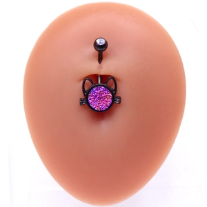 Macro view of black plated cat navel ring with purple glitter detail on silicone model