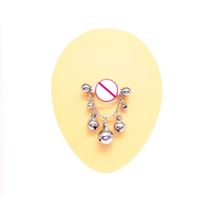 Detail of silver nipple ring with colorful bells and sparkling crystal rhinestones
