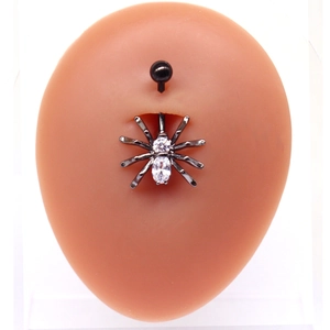 Detailed view of punk spider belly ring with white zircons on skin-tone model