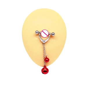 Detail of stainless steel nipple shield with hanging chains and red bells on skin model