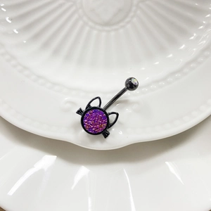 Detail of black cat belly ring featuring sparkly purple glitter and clear rhinestone
