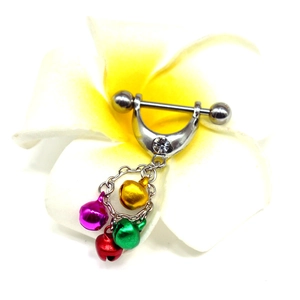 Macro view of stainless steel nipple ring with colorful bells and plumeria flower