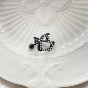Gothic belly button ring with black heart, arrows, and white rhinestones detail